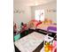 Bright bedroom features wood floors, a play tent, a plush rug and cartoon wall decor at 1361 Sterling Oaks Dr, Casselberry, FL 32707