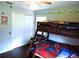 bedroom has wood floors, bunk beds with a Spiderman theme, and a playful cartoon theme at 1361 Sterling Oaks Dr, Casselberry, FL 32707