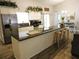 Modern kitchen features stainless steel appliances, granite countertops, and breakfast bar at 1361 Sterling Oaks Dr, Casselberry, FL 32707