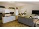 Bright, open-concept living space with a modern kitchen, wood floors, and dining area at 1361 Sterling Oaks Dr, Casselberry, FL 32707