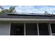 Solar panels on the roof of the house seen above a sliding glass door at 1361 Sterling Oaks Dr, Casselberry, FL 32707