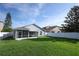Exterior of home with a screened in patio and large backyard at 14130 Leicester Ln, Orlando, FL 32828