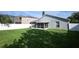 Exterior of house with a large grass backyard and white fence at 14130 Leicester Ln, Orlando, FL 32828
