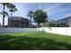 Spacious backyard featuring a white fence with view of a screened-in pool at 14130 Leicester Ln, Orlando, FL 32828