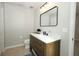 Stylish bathroom with a sleek wood vanity, modern fixtures, and a rectangular mirror at 14130 Leicester Ln, Orlando, FL 32828