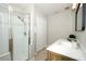 Bright bathroom featuring a glass-enclosed shower and a vanity with white countertop at 14130 Leicester Ln, Orlando, FL 32828