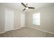 Neutral bedroom with two closets, a ceiling fan, and a bright window at 14130 Leicester Ln, Orlando, FL 32828