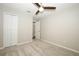 Bedroom features neutral carpet, paint, ceiling fan, and closet at 14130 Leicester Ln, Orlando, FL 32828