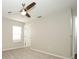 Bright bedroom featuring carpet, a ceiling fan, and a large window at 14130 Leicester Ln, Orlando, FL 32828