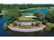 An eye-level shot of a beautifully landscaped Stoneybrook community sign surrounded by water and greenery at 14130 Leicester Ln, Orlando, FL 32828