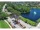Scenic view of the community entrance with a pond, fountain, and lush landscaping around the Stoneybrook community at 14130 Leicester Ln, Orlando, FL 32828