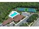 Aerial view showcasing community pool, tennis courts, and ample parking, perfect for an active lifestyle at 14130 Leicester Ln, Orlando, FL 32828