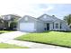 Charming single-story home with a well-manicured lawn and a two-car garage, located in a desirable neighborhood at 14130 Leicester Ln, Orlando, FL 32828
