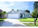 Charming single-story home with well-maintained landscaping and a two-car garage at 14130 Leicester Ln, Orlando, FL 32828