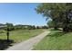 Picturesque golf course with a smooth walking path and lush green scenery surrounded by mature trees at 14130 Leicester Ln, Orlando, FL 32828