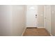 View of hallway featuring ceramic tile floor, neutral paint, and a white front door at 14130 Leicester Ln, Orlando, FL 32828