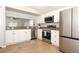 Kitchen showcasing stainless steel appliances, granite countertops, and white cabinetry at 14130 Leicester Ln, Orlando, FL 32828