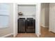 Laundry closet featuring modern washer and dryer units with shelf for supplies at 14130 Leicester Ln, Orlando, FL 32828