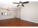 Inviting living room features wood flooring, modern light fixture and opening to the kitchen with bar seating at 14130 Leicester Ln, Orlando, FL 32828