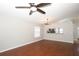 Inviting living room showcases wood floors, ceiling fan, and view of the kitchen through a pass-through window at 14130 Leicester Ln, Orlando, FL 32828