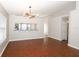 Bright living room featuring hardwood floors, modern lighting, and a convenient pass-through to the kitchen at 14130 Leicester Ln, Orlando, FL 32828