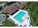 Aerial view of a community pool with lounge chairs and a spacious pool deck at 14130 Leicester Ln, Orlando, FL 32828