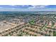 Expansive aerial view of a residential community with single Gathering homes, modern apartments, and green surroundings at 1442 Moon Valley Dr, Davenport, FL 33896