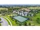 Aerial view of community tennis courts and putting green near clubhouse at 1442 Moon Valley Dr, Davenport, FL 33896