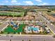 Stunning aerial view featuring a community pool, playground, and beautiful landscaping at 1442 Moon Valley Dr, Davenport, FL 33896