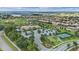 Wide aerial view of community amenities, including tennis courts, a putting green, and parking at 1442 Moon Valley Dr, Davenport, FL 33896