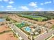 Beautiful aerial view of community featuring pool, playground, golf course, and lake at 1442 Moon Valley Dr, Davenport, FL 33896