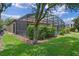 The screened-in pool area is surrounded by lush landscaping, offering a private outdoor retreat at 1442 Moon Valley Dr, Davenport, FL 33896