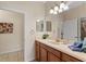 Bright bathroom with a spacious vanity, decorative mirror and convenient access to the shower and bedroom at 1442 Moon Valley Dr, Davenport, FL 33896