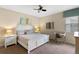 Bright bedroom featuring neutral tones, a ceiling fan, and a comfortable bed with matching nightstands at 1442 Moon Valley Dr, Davenport, FL 33896