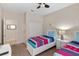 Bedroom showcasing twin beds, neutral tones, and ample closet space, perfect for a shared room at 1442 Moon Valley Dr, Davenport, FL 33896