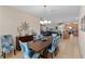 Charming dining room with a stylish chandelier and seamless flow into the kitchen at 1442 Moon Valley Dr, Davenport, FL 33896