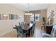 Formal dining room showcasing stylish chairs and a modern chandelier above a wooden table with tile flooring at 1442 Moon Valley Dr, Davenport, FL 33896