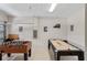 Spacious game room with foosball and shuffleboard tables for Gathering entertainment and leisure at 1442 Moon Valley Dr, Davenport, FL 33896