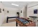 This game room features foosball and shuffleboard tables, offering entertainment for all at 1442 Moon Valley Dr, Davenport, FL 33896