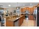 Modern kitchen with granite countertops, stainless steel appliances, and open access to the living area at 1442 Moon Valley Dr, Davenport, FL 33896