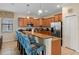 Open-concept kitchen featuring a breakfast bar, stainless steel appliances, and lots of cabinets at 1442 Moon Valley Dr, Davenport, FL 33896