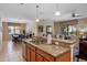 Kitchen with a breakfast bar, stainless appliances, and access to the dining and living areas at 1442 Moon Valley Dr, Davenport, FL 33896