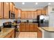 Well-lit kitchen with stainless steel appliances, granite countertops, and ample cabinet space at 1442 Moon Valley Dr, Davenport, FL 33896
