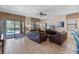 Comfortable living room with tile flooring, a ceiling fan, and sliding glass doors to the pool at 1442 Moon Valley Dr, Davenport, FL 33896