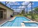 Screened-in pool area, featuring a shimmering pool and spa for relaxation and enjoyment at 1442 Moon Valley Dr, Davenport, FL 33896