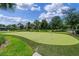 Well-manicured community putting green surrounded by lush landscaping at 1442 Moon Valley Dr, Davenport, FL 33896