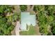 Aerial view of a home featuring a metal roof, circular driveway, and mature trees at 1908 S Farm Rd, Deland, FL 32720