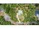 Aerial view of a wooded property with mature trees and a red outline of the lot at 1908 S Farm Rd, Deland, FL 32720