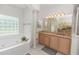 Elegant bathroom featuring granite counters, tiled floors, and a large soaking tub at 1908 S Farm Rd, Deland, FL 32720
