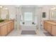 Bright bathroom featuring a large tub, columns, and double vanities at 1908 S Farm Rd, Deland, FL 32720